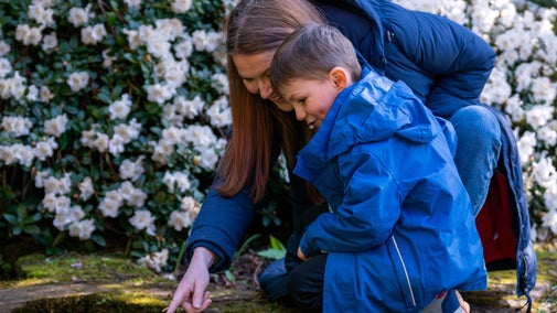Mother and child exploring the garden in Spring